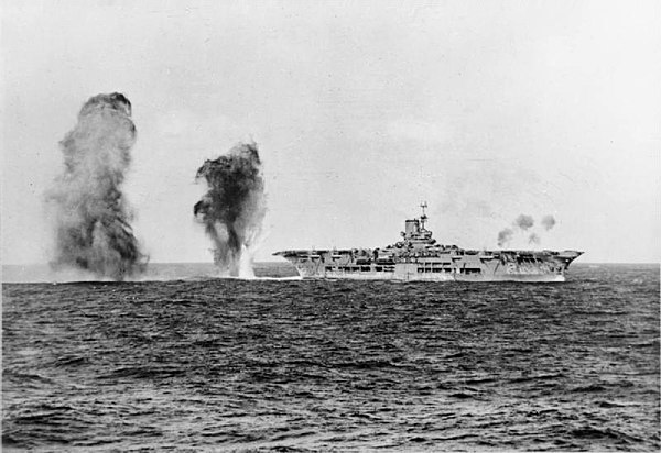 Top: Italian heavy cruiser Bolzano during the battle. Bottom: British aircraft carrier Ark Royal straddled by enemy bombs
