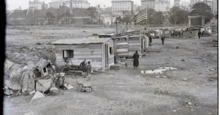 Hooverville in Alabama during the Great Depression. An American flag flies over one of the shanties. Hooverville.jpg.webp