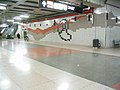 Complex artwork don the walls on the concourse level; the outline of the large outlined images are further inlaid with single-colour images at Don Mills station