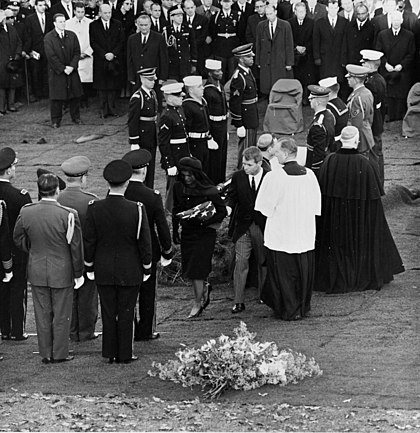 Jacqueline Kennedy and Robert F. Kennedy walk away from Kennedy's casket after lighting the Eternal Flame