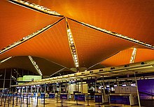 The check-in counters in KLIA Main Terminal. The roof structure of the airport was inspired from the traditional Malay architecture.