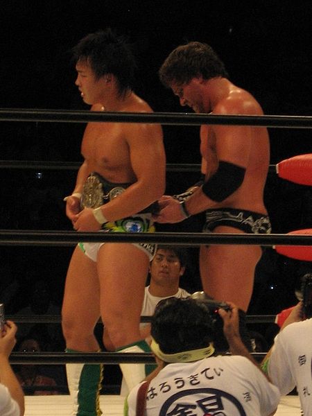Sabin (right) fastening the World Junior Heavyweight Championship belt around the waist of Katsuhiko Nakajima, after Nakajima had defeated Sabin to re