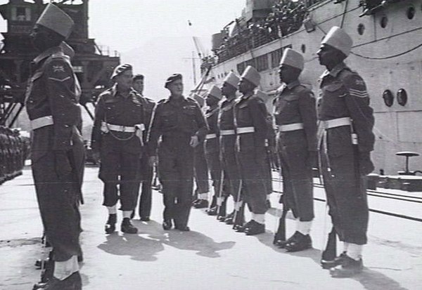Major General David Cowan, General Officer Commanding BRINDIV, inspects Indian troops at Kure, 30 March 1946.