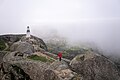 Image 179Man wearing a red jacket at Monsanto Castle in a foggy morning, Aldeia de Monsanto, Portugal