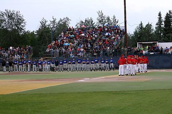 The players line up before the first pitch of the 2011 Midnight Sun Game.