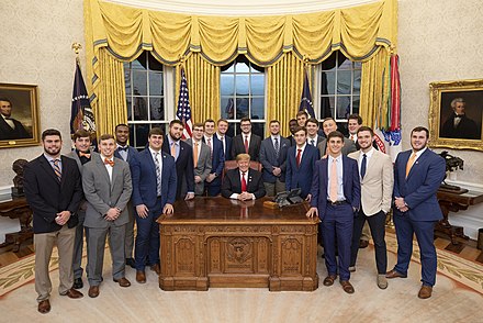 Members of the 2018 Clemson Tigers football team pose with President Trump in the Oval Office
