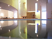 Interior of the chapel, reflected in the baptismal font. Seattle U St Ignatius 20.jpg
