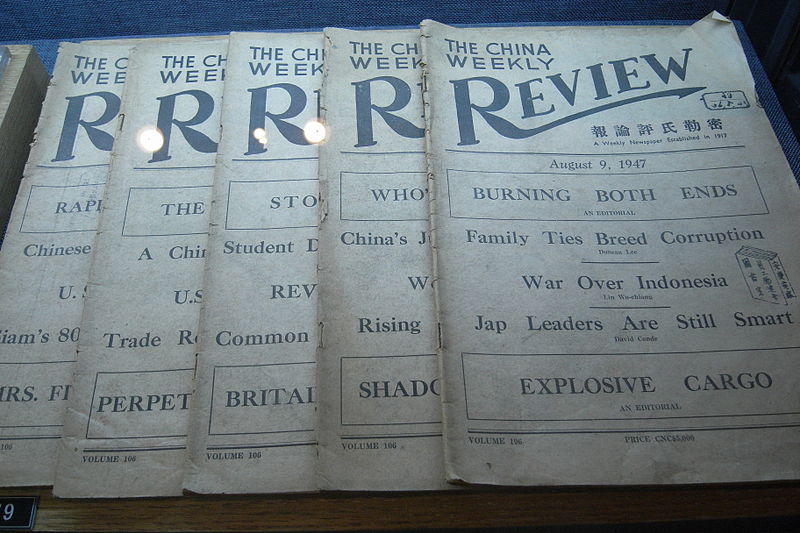 Stack of pamphlets with the title of "The China Weekly Review". The top copy is from August 9, 1947. "Review" is in script and prominent. Used with permission from "Wikimedia Commons" (https://upload.wikimedia.org/wikipedia/commons/thumb/7/7a/The_China_Weekly_Review%2C_Nanjing_Massacre.jpg/800px-The_China_Weekly_Review%2C_Nanjing_Massacre.jpg?20100901012838)