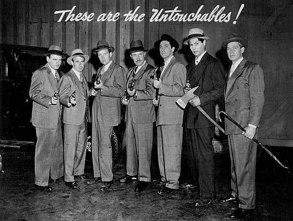 In the Desilu Playhouse version of The Untouchables, L-R: Bob Osterloh, Eddie Firestone, Robert Stack, Keenan Wynn, Peter Leeds, Abel Fernandez and Bi