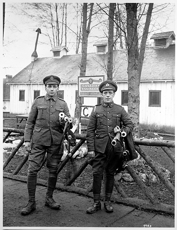 Two military engineers with bagpipes in front of the Canadian Engineers Building at Hastings Park, 1915.