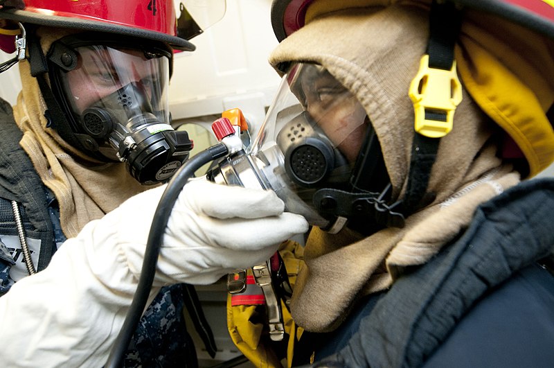 File:US Navy 120130-N-PB383-093 A Sailor puts on the mouthpiece to his self-contained breathing apparatus during a total ship survivability exercise.jpg