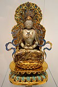 Statue of Vairocana, made in China during the Qing dynasty. 19th century. Made of jade, gilt bronze, enamel, pearls and kingfisher feathers. Displayed at the Royal Ontario Museum.