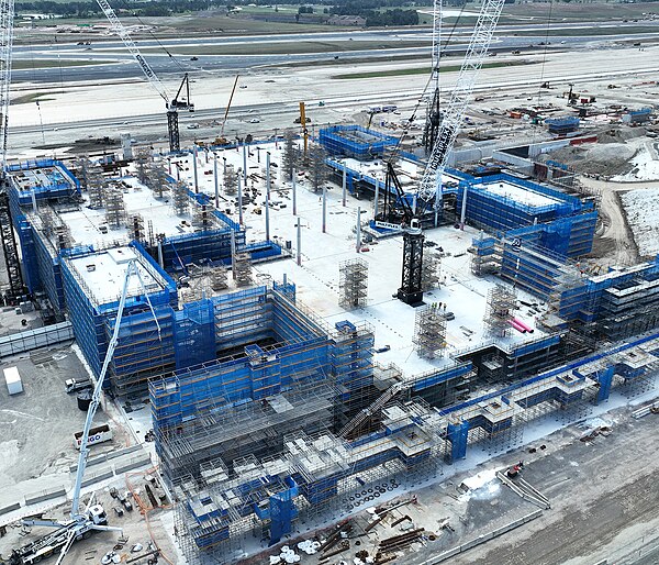 Aerial view of the airport terminal under construction as of March 2023