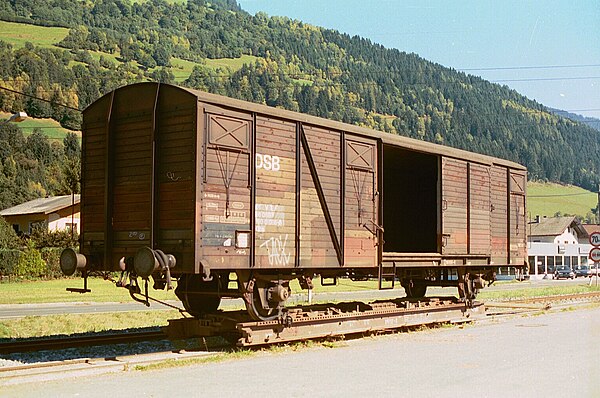 A DSB standard gauge freight car on a narrower gauge transporter wagon