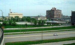 The site of Target Field, two days before construction commenced on May 21, 2007. The location is bordered by 7th St. N (overpass on left), the Hennepin Energy Recovery Center, 5th St. N (overpass on the right side), and the 394 exits and downtown parking ramp (foreground). The tall red building is the Ford Centre. 051907-009-TwinsBallparkSite.jpg