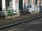 View on the street Tussen Kadijken with entries of houses and shadows on the pavement, Amsterdam city, 2013; photo, Fons Heijnsbroek