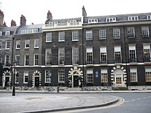 Georgian terraced housing in Bedford Square (1780), one of many squares built in the west of London as the city grew Aaschool.JPG
