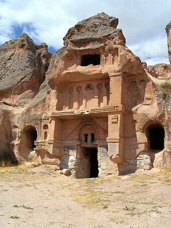 Facade of an ancient church called Açik Saray, literally meaning "Open Palace", carved into the valley walls in Gülşehir, Cappadocia.