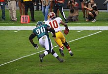 Logan pursues Redskins quarterback Robert Griffin III in 2013. Bennie Logan13.jpg