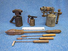 Historical soldering irons (front) and torches (back) Benzinlotlampen und Lotkolben.jpg