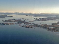 Bjørnefjorden with Austevoll archipelago, Folgefonna glacier in the distance