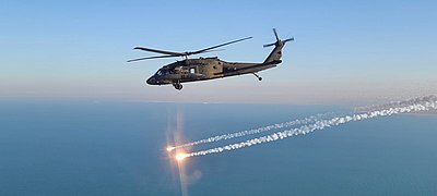 A UH-60 Black Hawk helicopter, operated by Soldiers with A Company, 2-104th General Support Aviation Battalion, 28th Expeditionary Combat Aviation Brigade, flies over Iraq on Jan. 1, 2021. (U.S. Army photo by Sgt. Andrew Johnson) Black Hawk flares.jpg