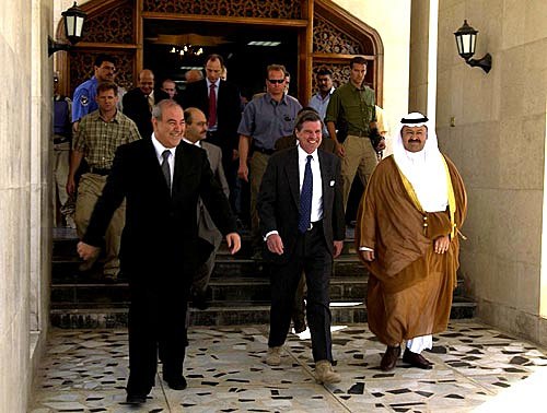 Iraqi Prime Minister Ayad Allawi (left), Bremer, and President Sheikh Ghazi Mashal Ajil al-Yawer following a ceremony celebrating the transfer of full