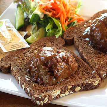 Broodje bal [nl], a slice of bread with a meatball and gravy, halved meatball served on slices of Dutch whole wheat bread.