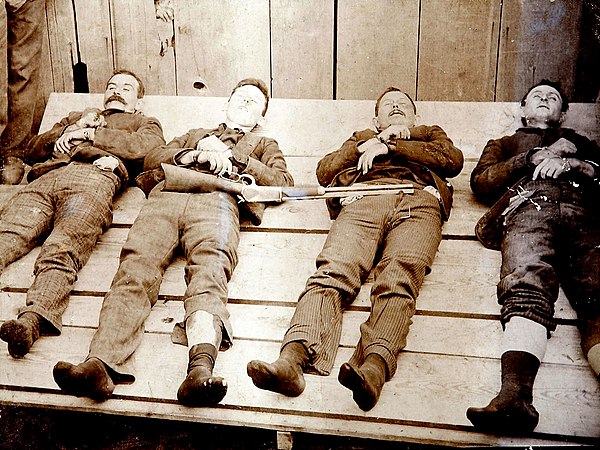 Members of the Dalton Gang on display following the Battle of Coffeyville in 1892 – left to right: Bill Power, Bob Dalton, Grat Dalton, and Dick Broad