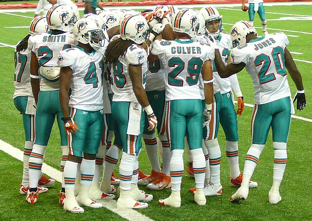 The Dolphins' defensive backs huddle during the preseason opener in Atlanta.