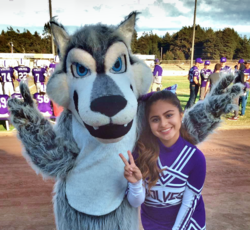 Photo of Fort Bragg High School mascot posing with cheerleader at a football game