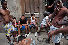 Youth gang playing cards in front of a house. Havana (La Habana), Cuba