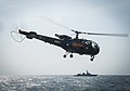 An Alouette III helicopter assigned Aslat flies by USS Mitscher in Indian Ocean in 2014.