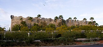 This show building houses the Indiana Jones Adventure at Disneyland. It is visible from outside the park, but it is hidden from guests in the park by tree-covered berms. Indiana Jones show building.jpg