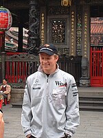 a smiling young Räikkönen visits a temple