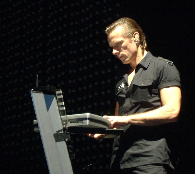 Larry Mullen playing keyboards.