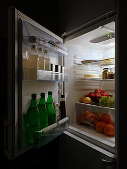 Food in a refrigerator with its door open Open refrigerator with food at night.jpg