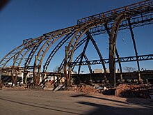 Curved wall and roof frame members of drill floor.  Note base of columns is set on a roller pin (to accommodate movement of frame caused by temperature changes?)