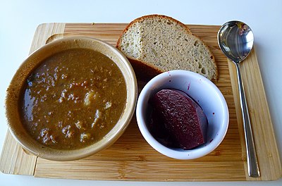 A dish of scouse, with beetroot and crusty bread.