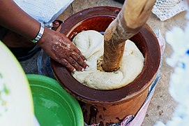 Using a mortar and pestle to pound fufu in Ghana