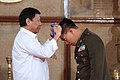 President Rodrigo Duterte awards a medal to Lieutenant Colonel Eliglen Villaflor, an outstanding soldier awardee.jpg