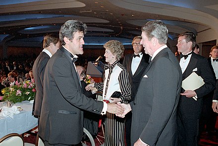 Leno shaking hands with President Ronald Reagan in April 1987