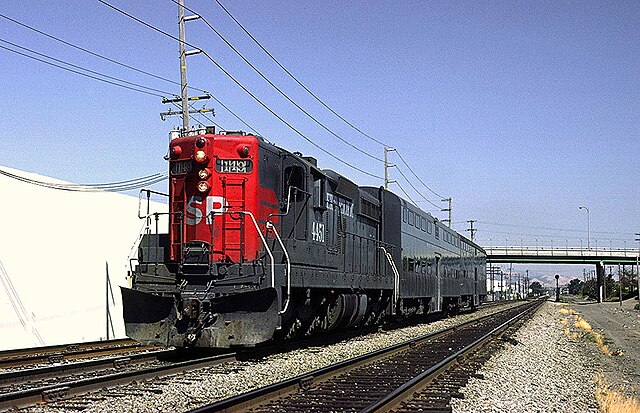 West (railroad north) of Santa Clara, a Southern Pacific EMD SD9E #4451 leads a two-car train before the Caltrain takeover