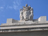 Sculpture: thought and deed with the coat of arms of Pius XI.