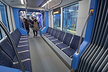 Unlike the S70, the S700 has longitudinal seating in the center section, with a wider aisle. Sound Transit Siemens S700 middle seating (48099119456).jpg