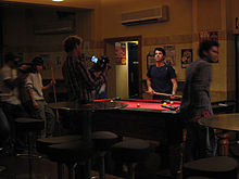 Chaser member Chas Licciardello along with Chris Taylor (right) and ABC crew, doing an Ad Road-Test on Godfrey's vacuum cleaners The Chaser Godfrey's Ad Road Test (28 August 2006, Sydney) 3.jpg