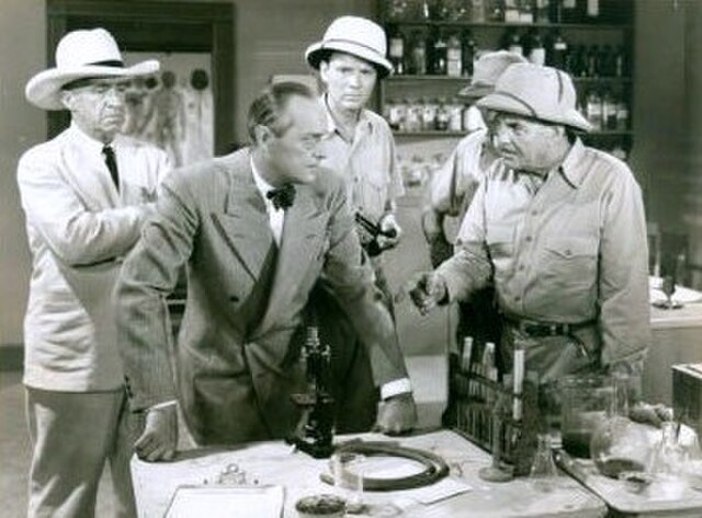 Movie still for Tiger Fangs (1943), J. Farrell MacDonald (left), Arno Frey (center), Frank Buck (right)