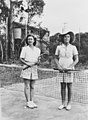 Two young ladies standing next to a tennis net, 1947 (6897282446).jpg