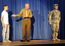 U.S. Soldiers reenactment of Audie Murphy military biography, SAMC, Fort Gordon, Ga., 12 Dec 2009 U.S. Soldiers perform an reenactment of Audie Murphy military biography, on stage, during an induction ceremony, at Sergeant Audie Murphy Club, at Fort Gordon, Ga. 091202-A-NF756-002.jpg