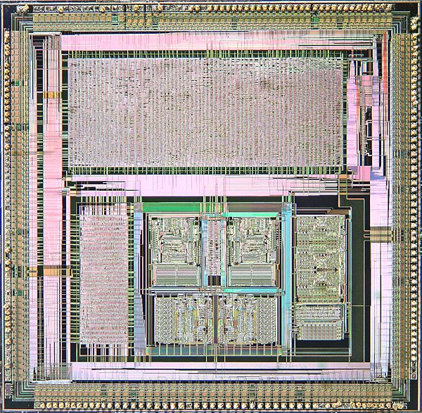 Microscope photograph of custom ASIC (486 chipset) showing gate-based design on top and custom circuitry on bottom